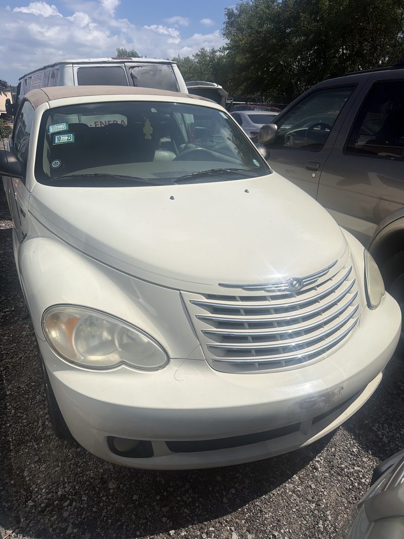 White Chrysler PT Cruiser parked on the gravel at the Halsted junk car yard in Chicago