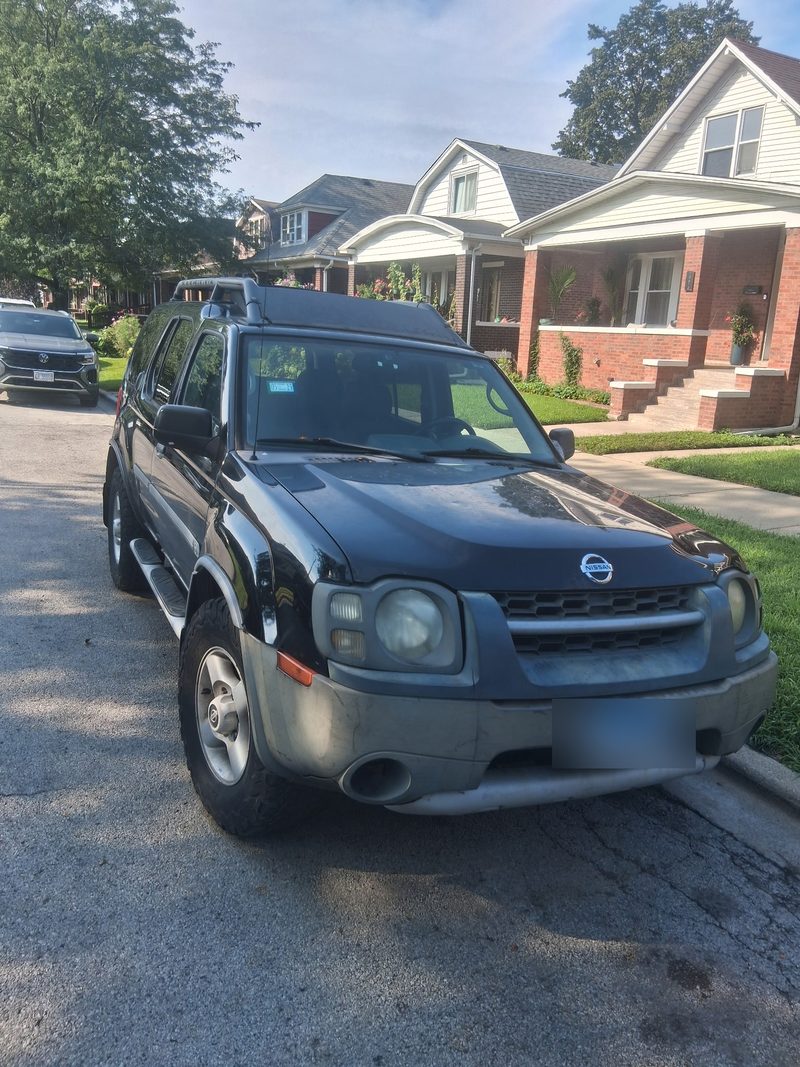Black Nissan Xterra SUV bought for cash on a residential street in Chicago by Halsted Cash For Junk Cars